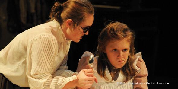 Annie Sullivan (senior Margot Leiner) attempts to teach Helen Keller (sophomore Greta Hallberg) to eat with utensils. 
