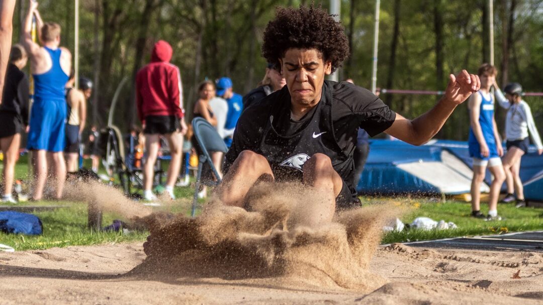 First-year Natavon Nix lands at the Blake Relay meet. He broke the school record for triple jump. Photo by Ezra Victor.